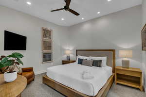 Carpeted bedroom with recessed lighting and a ceiling fan