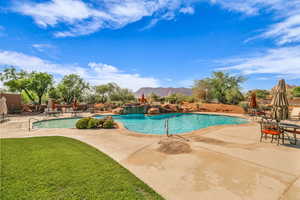 Community pool with a patio and a mountain view