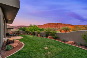 Fenced backyard featuring a patio area and a mountain view