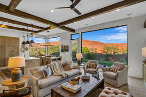 Living area with beam ceiling, ceiling fan, recessed lighting, a mountain view, and light tile patterned flooring