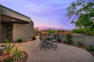 Patio terrace at dusk featuring outdoor dining space and a patio