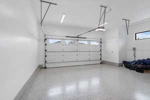 Garage with a garage door opener and baseboards