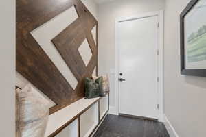 Doorway featuring baseboards