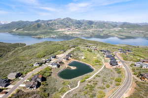 View of property location with a water and mountain view and nearby suburban area