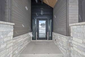 Entrance to property with stone siding