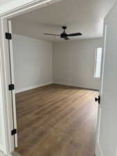 Empty room with light wood-type flooring and ceiling fan