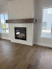 Detailed view of a fireplace and wood finished floors