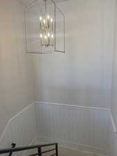 Detailed view of a wainscoted wall and a chandelier
