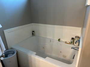 Full bath with a tub with jets