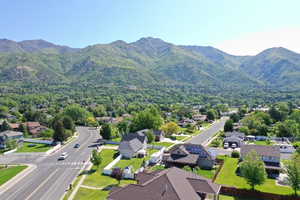 Aerial perspective of suburban area with a mountainous background