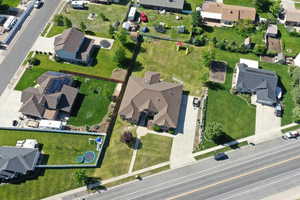 Aerial view of property and surrounding area with nearby suburban area