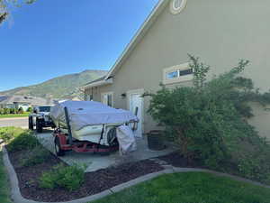 View of side of property featuring stucco siding and a mountain view