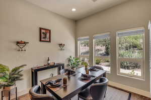 Dining area with baseboards, wood finished floors, and recessed lighting