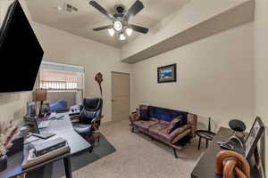 Office area with carpet floors and a ceiling fan