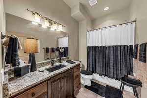 Full bath featuring vanity, toilet, tile patterned floors, and shower / tub combo