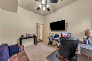 Office with carpet and a ceiling fan