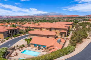 Aerial perspective of suburban area with a mountainous background and a pool area