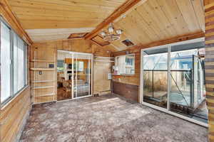 Unfurnished sunroom featuring vaulted ceiling and a chandelier