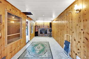 Hallway with wooden walls and carpet floors