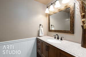 Bathroom with vanity and wainscoting
