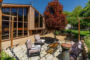 View of patio / terrace with stairs and a sunroom