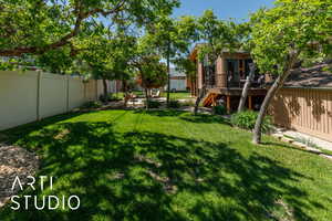 View of yard featuring a wooden deck and stairway