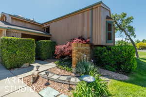 View of side of home with a yard