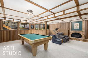 Playroom with carpet floors, billiards table, and a brick fireplace