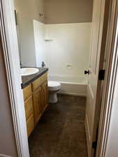 Bathroom featuring vanity, toilet, and tub / shower combination