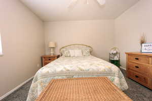 Bedroom with carpet floors, baseboards, and a ceiling fan