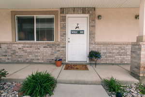 Entrance to property featuring stucco siding
