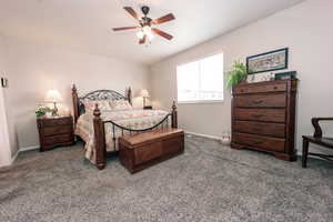 Bedroom with carpet floors, baseboards, and a ceiling fan