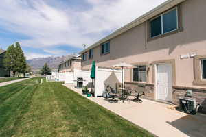 Rear view of house featuring a mountain view, cooling unit, stucco siding, a patio area, and stone siding
