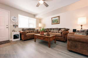 Living area with light wood-style flooring and ceiling fan