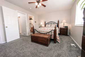 Bedroom with carpet, ensuite bath, baseboards, and ceiling fan