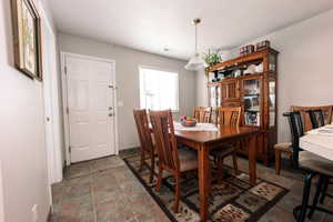 Dining room featuring stone finish flooring and baseboards