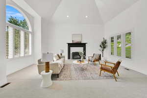 Front sitting room with plantation shutters and a fire place