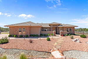 View of front of house with stone siding, stucco siding, and a tile roof