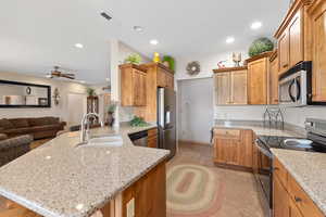 Kitchen with stainless steel appliances, a sink, a peninsula, recessed lighting, and open floor plan
