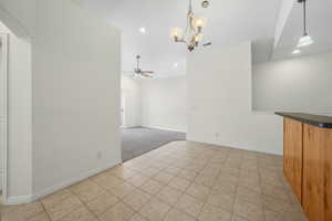 Unfurnished dining area with light tile patterned floors, a chandelier, recessed lighting, and a ceiling fan