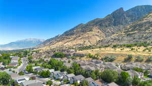 Aerial view of property's location with nearby suburban area and a mountainous background