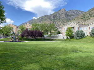 View of grassy yard with a mountain view