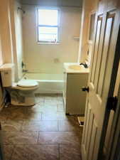 Bathroom featuring vanity, toilet, and bathtub / shower combination