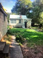 Back of house with big backyard