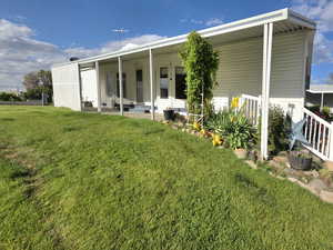 Rear view of property with a yard