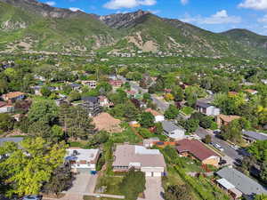 Aerial view of property's location featuring a mountain backdrop and nearby suburban area