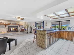 Kitchen with plenty of natural light, a kitchen bar, open floor plan, ceiling fan, and recessed lighting
