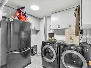 Laundry room with washer and clothes dryer