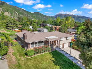 Aerial view of property and surrounding area featuring mountains