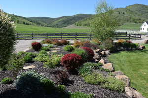 View of mountain backdrop featuring rural landscape